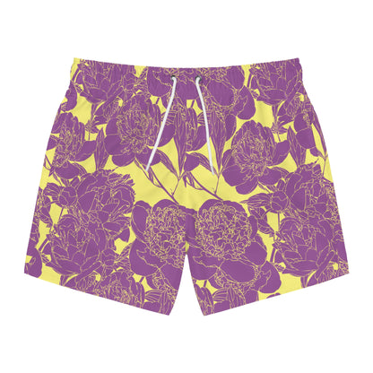 A pair of men's swim trunks featuring a bold purple floral pattern on a bright yellow background, with white drawstrings at the waist.