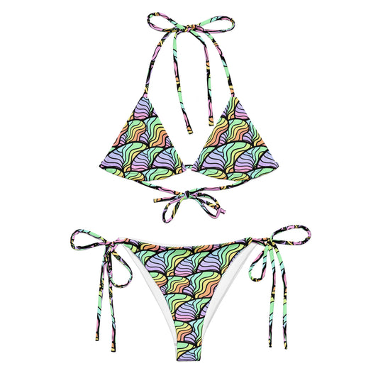 A two-piece string bikini set with a colorful wavy scale pattern in shades of purple, green, yellow, orange, and pink, displayed flat against a solid white background.